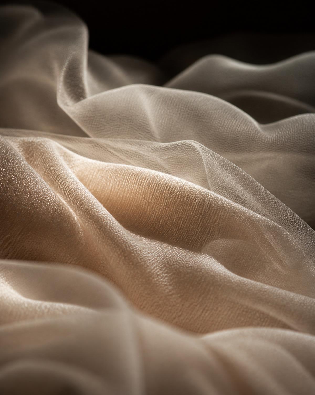 Macro study of soft, cloud-like textile folds catching gentle light